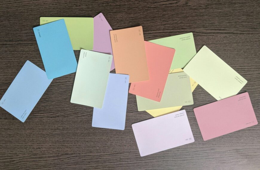 white green and yellow papers on brown wooden table