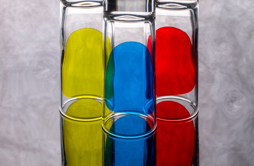 Three transparent vials with primary colors, yellow, blue and red.